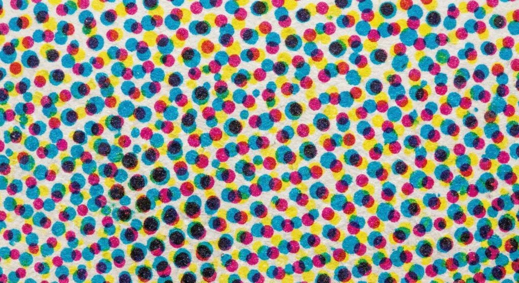 Extreme close up of CMYK halftone dots illustrating 300 dpi for printing resolution.