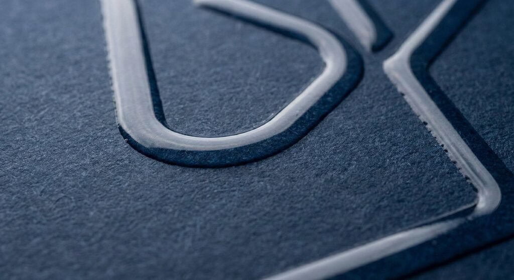 Cross-section diagram showing how Spot UV coating sits on top of matte lamination.